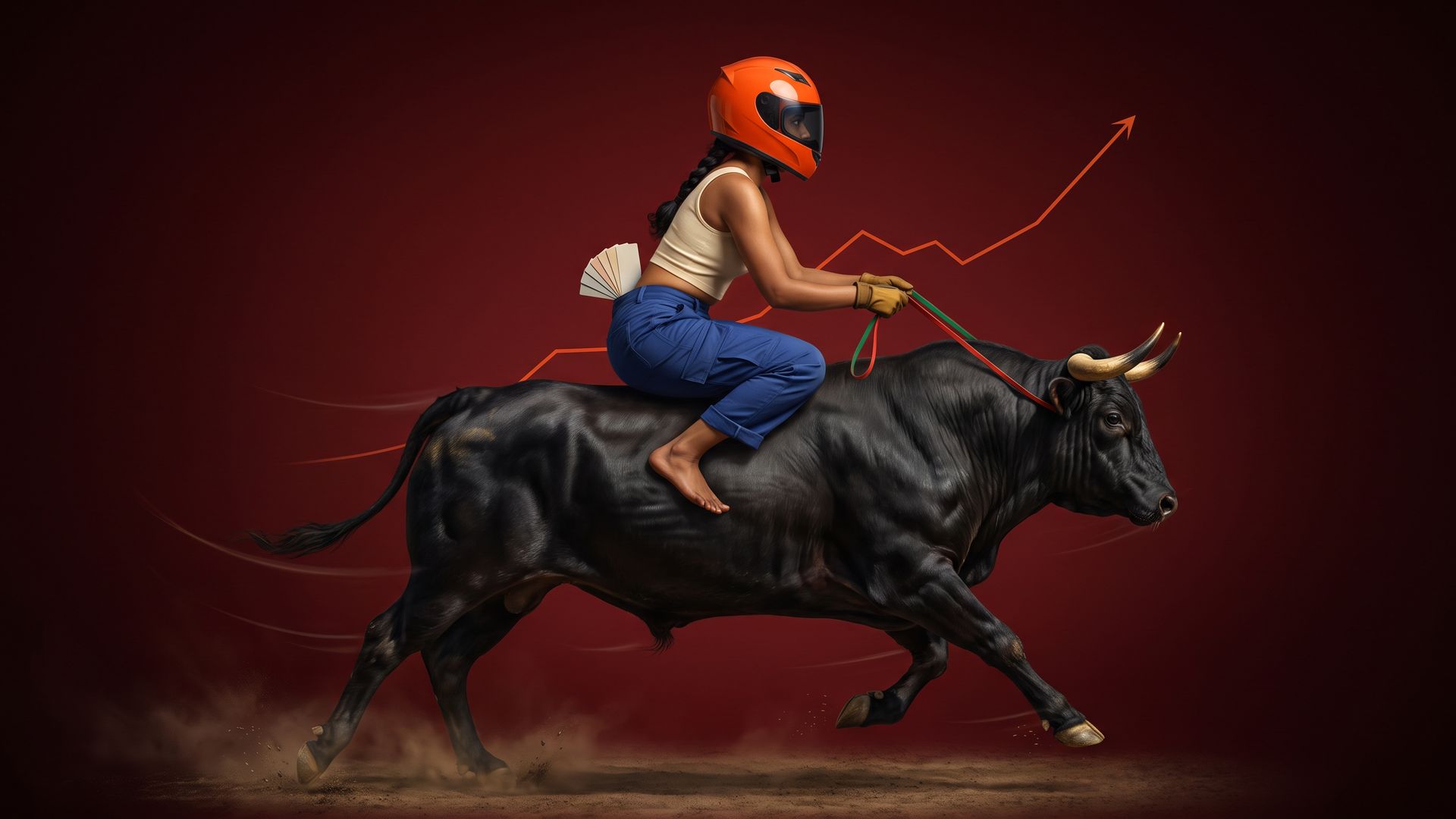 A young Indian woman in an orange racing helmet crouches barefoot on a galloping black bull, holding red and green reins against a deep crimson backdrop.